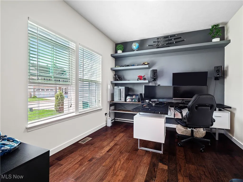 Office with wood finished floors and baseboards