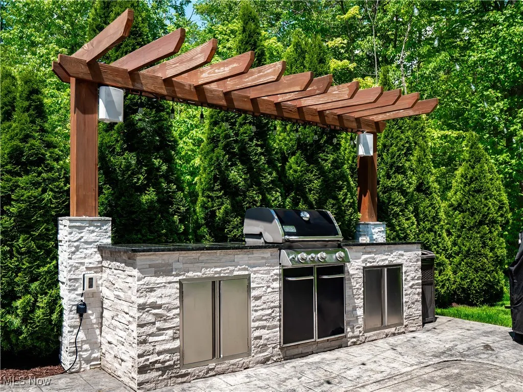 View of patio / terrace with an outdoor kitchen and a pergola