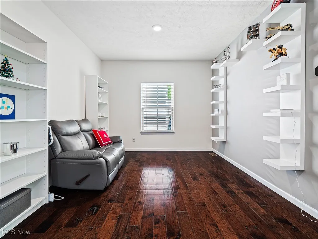 Living area featuring hardwood / wood-style flooring and baseboards