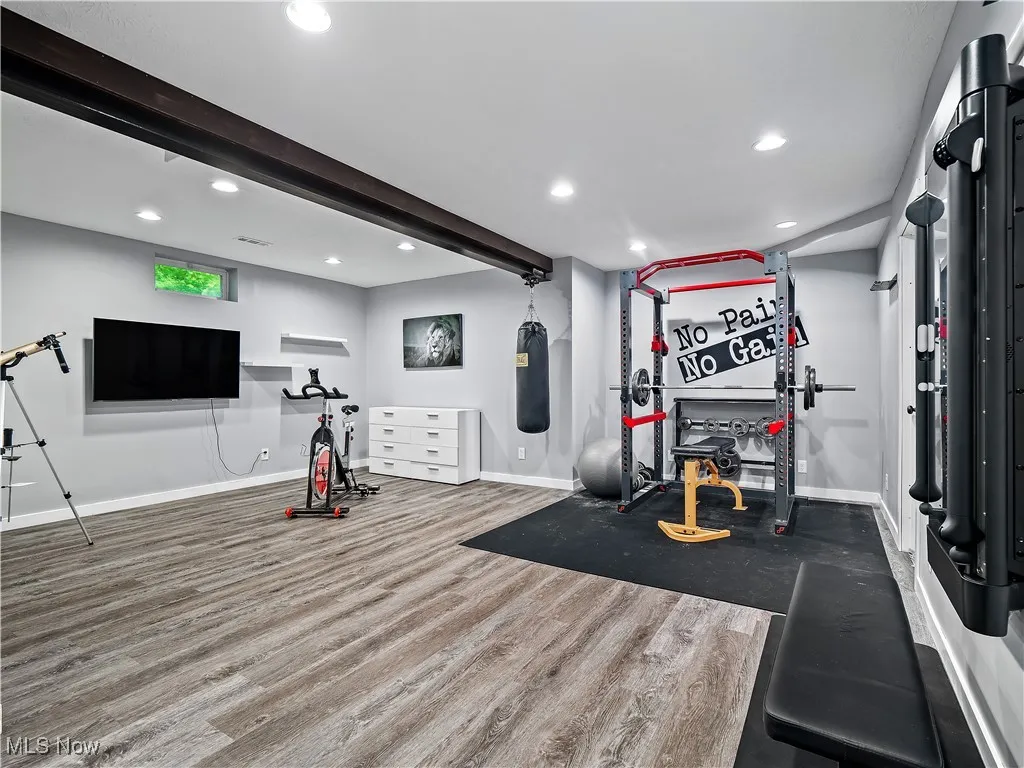 Workout room featuring wood finished floors and recessed lighting