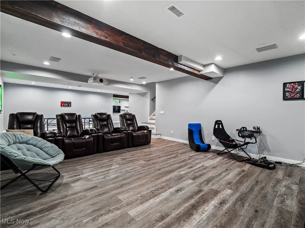 Cinema room with wood finished floors and recessed lighting