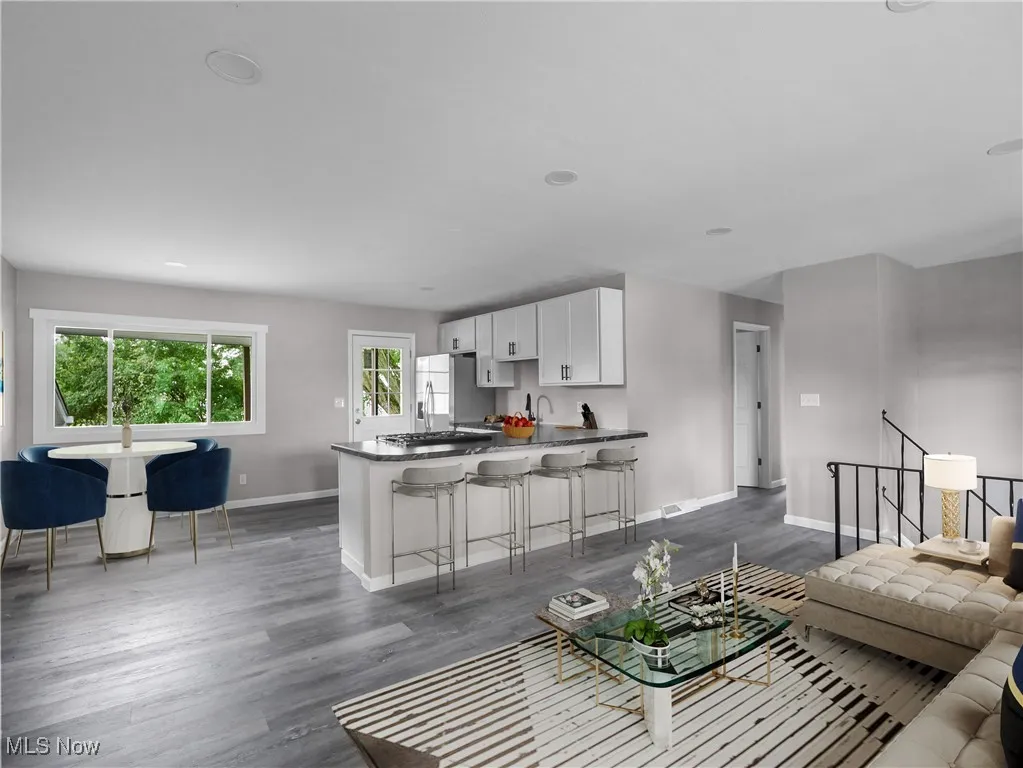Living room with baseboards and dark wood-style floors