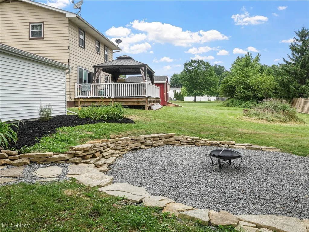 View of yard featuring a gazebo, a fire pit, a patio, and a wooden deck