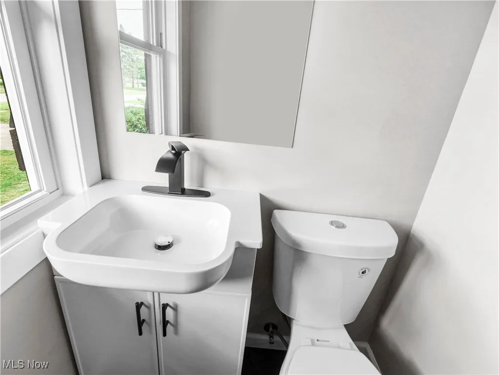 Half bathroom with a sink and toilet