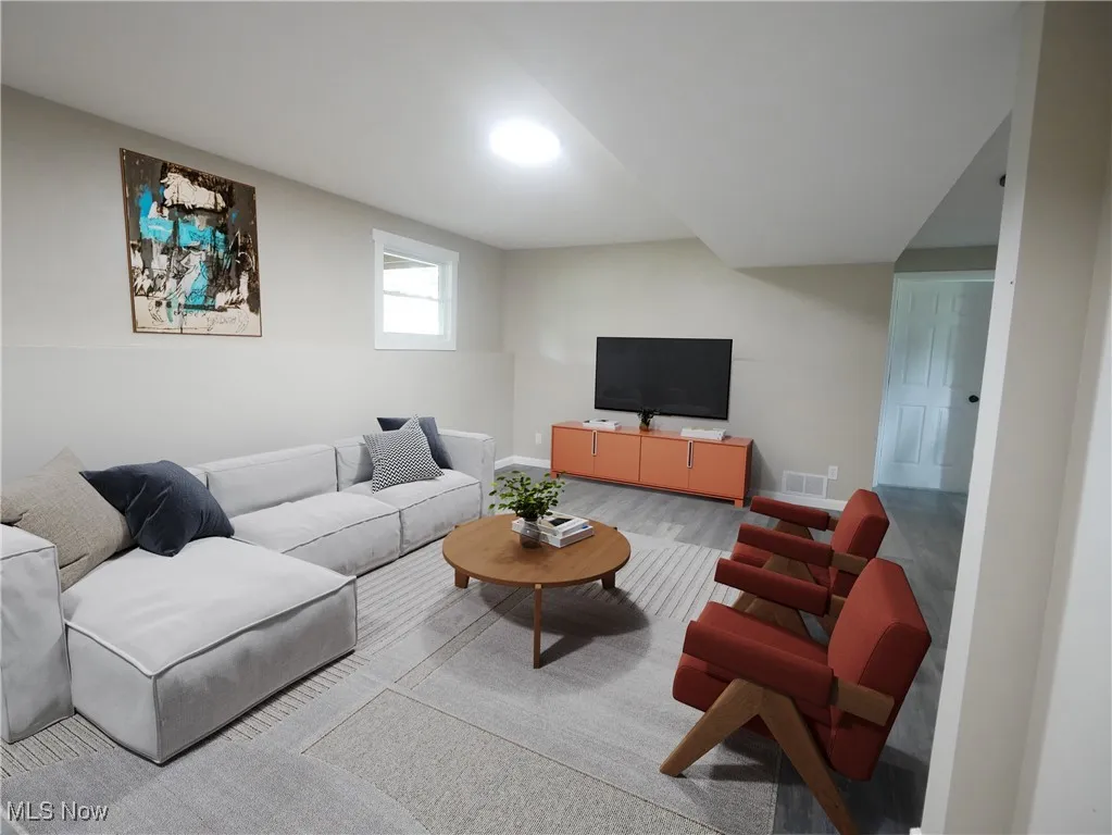 Living room featuring baseboards and wood finished floors