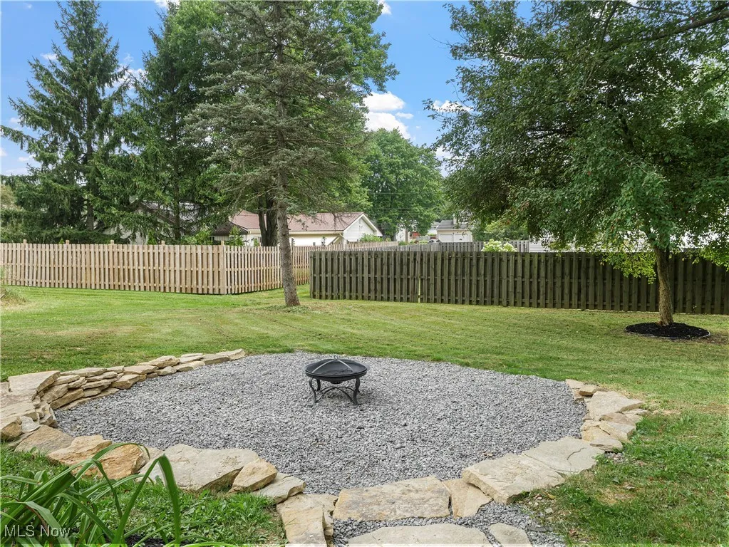 View of yard featuring an outdoor fire pit and a patio area