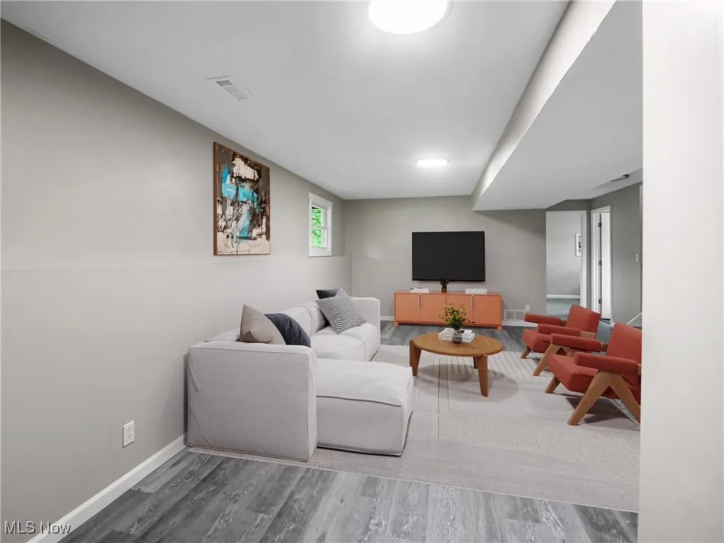Living room with baseboards and wood finished floors
