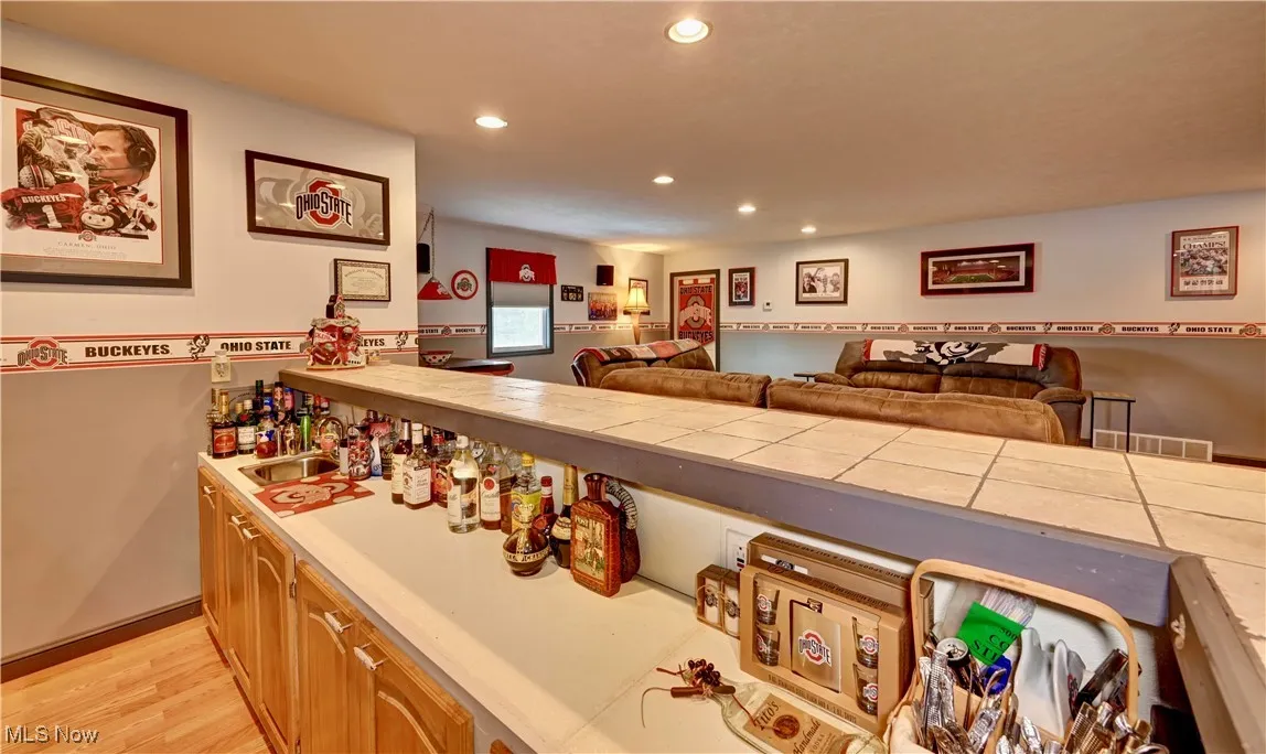 Bar area featuring recessed lighting and light wood finished floors