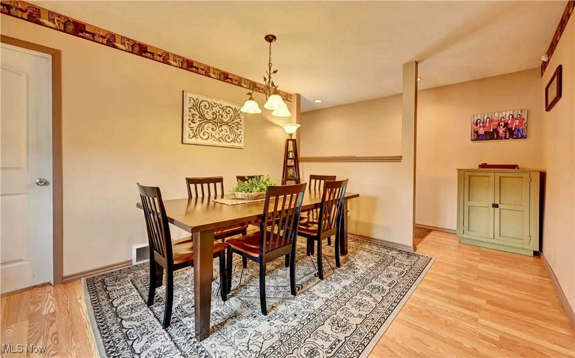 Dining area featuring light wood-type flooring and baseboards