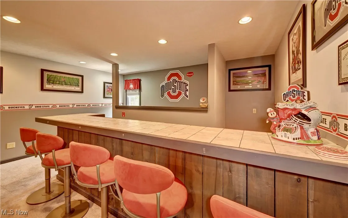 Indoor dry bar featuring recessed lighting and carpet