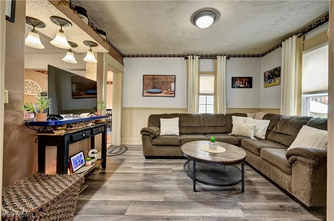 Living room featuring wainscoting and wood finished floors