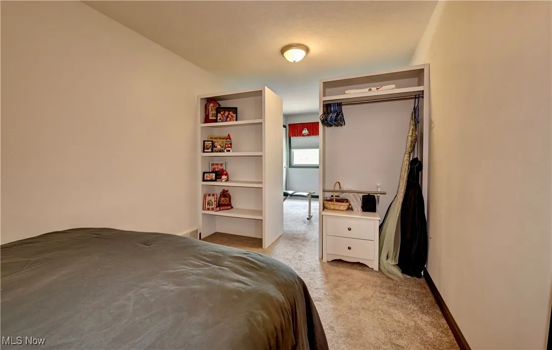 Carpeted bedroom with baseboards