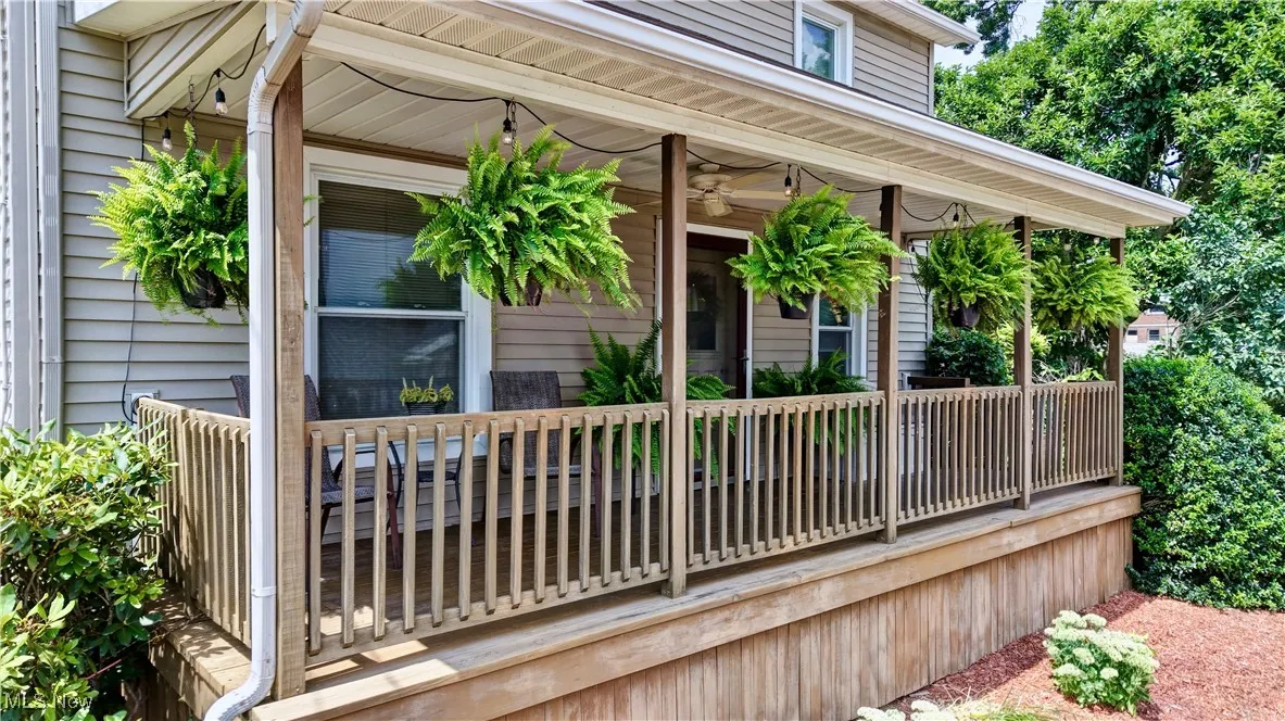 Doorway to property featuring a ceiling fan and a porch
