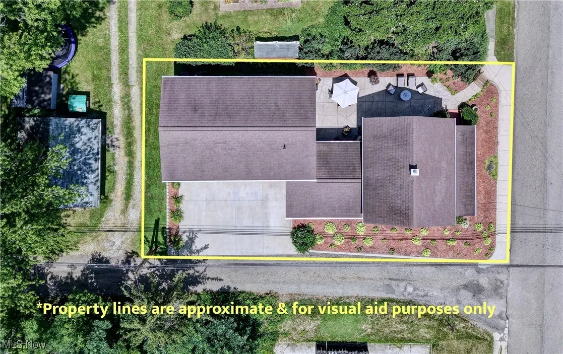 Aerial view of property and surrounding area with property parcel outlined