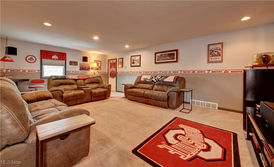 Carpeted living room with recessed lighting