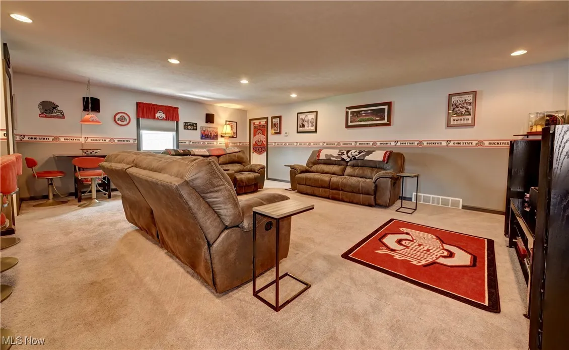 Living area with recessed lighting and light colored carpet