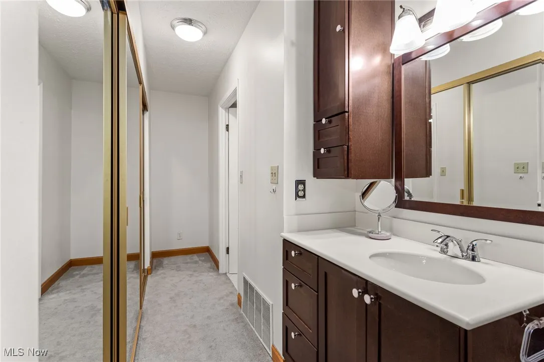 Bathroom featuring vanity and a textured ceiling