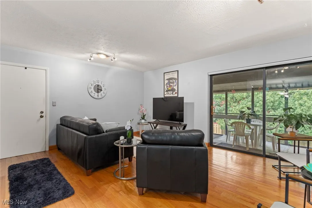 Living room with light wood-style flooring and a textured ceiling