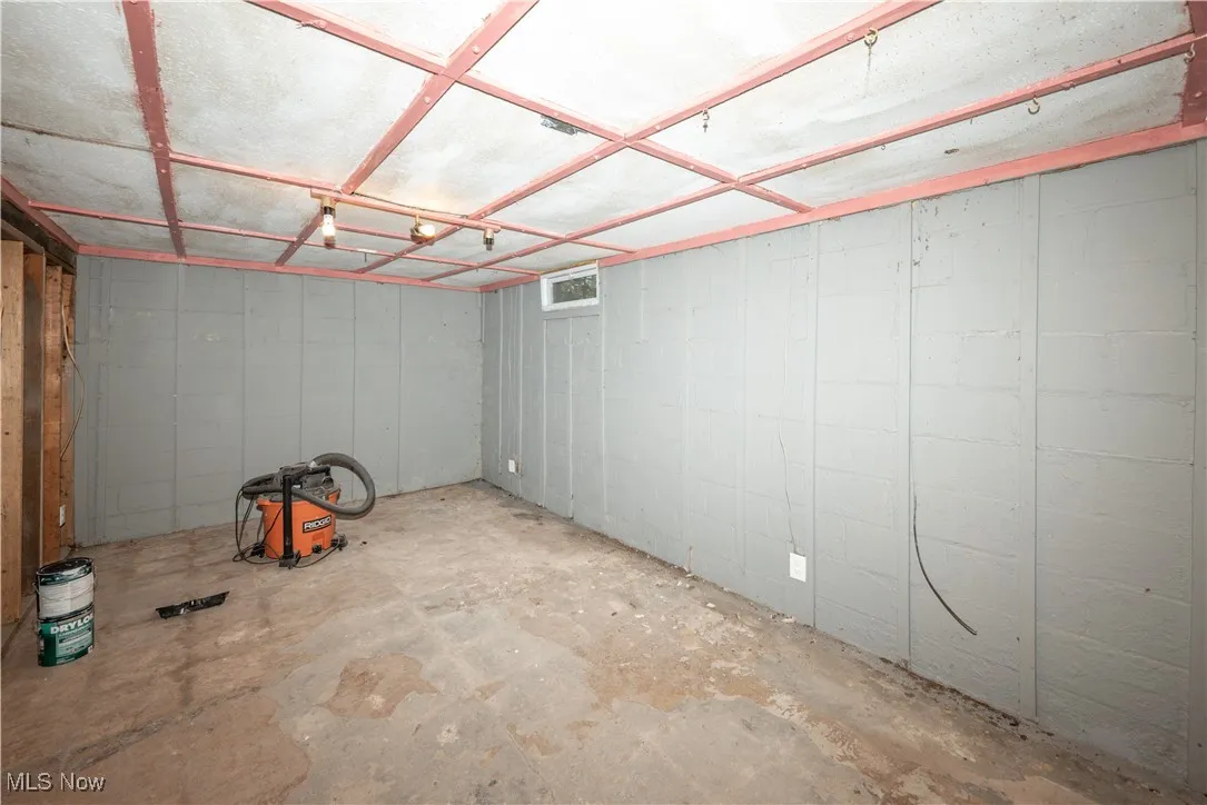Unfinished basement with concrete block wall