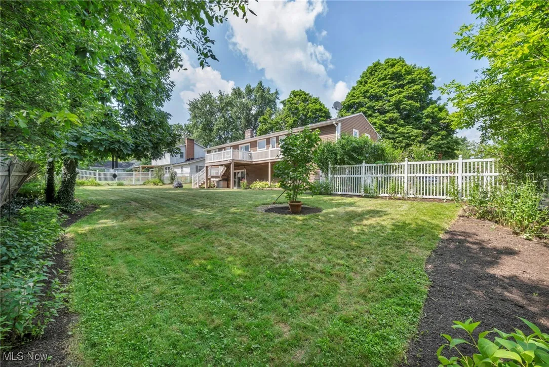 Fenced backyard with stairway and a deck