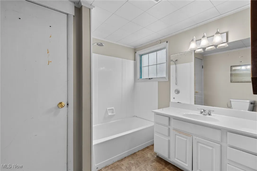 Bathroom with vanity and shower / bath combination