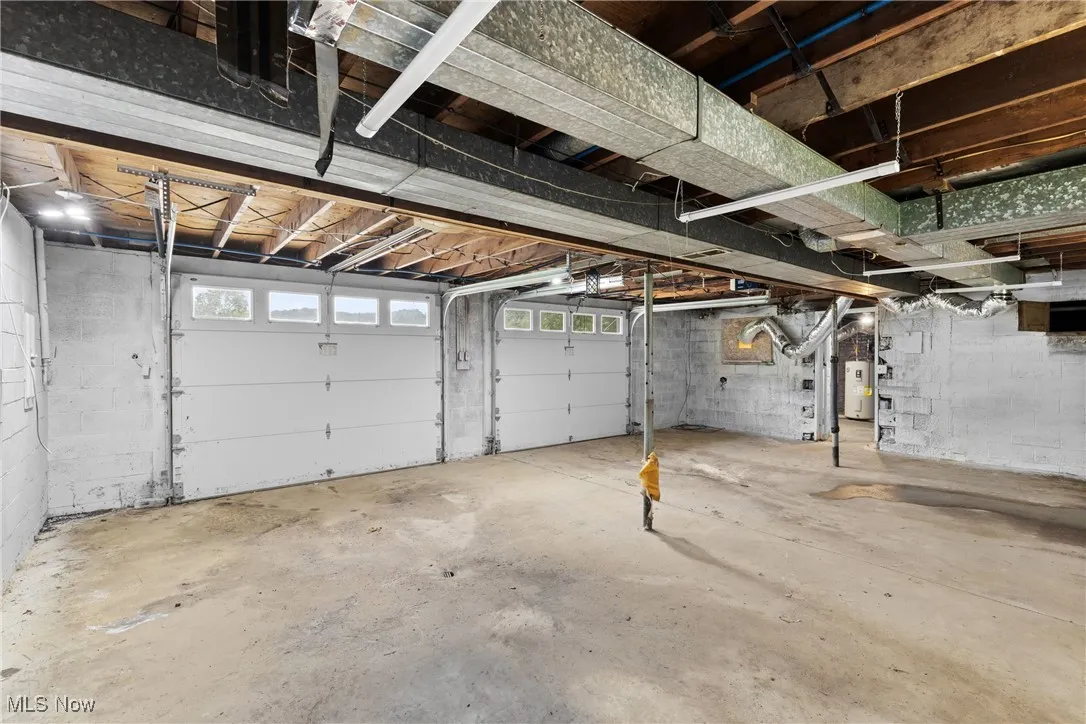 Garage featuring electric water heater