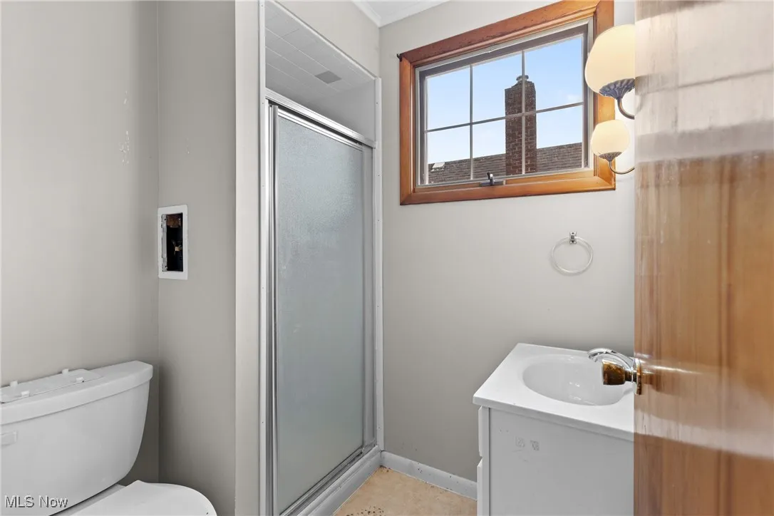Full bathroom featuring a shower stall and vanity