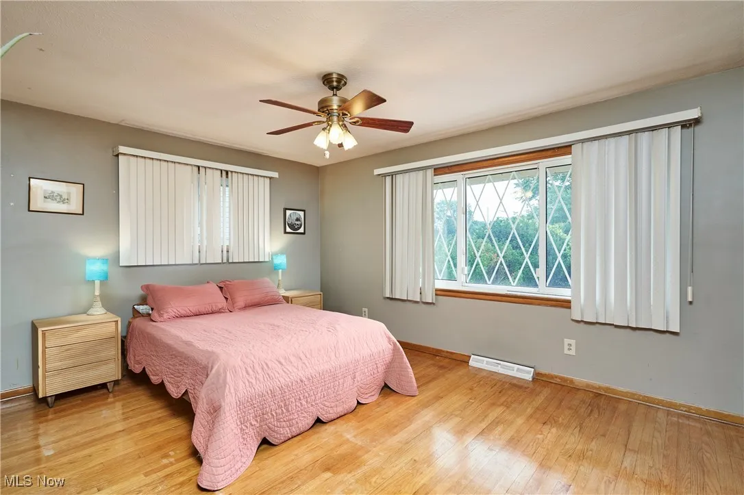 Bedroom with wood finished floors and ceiling fan