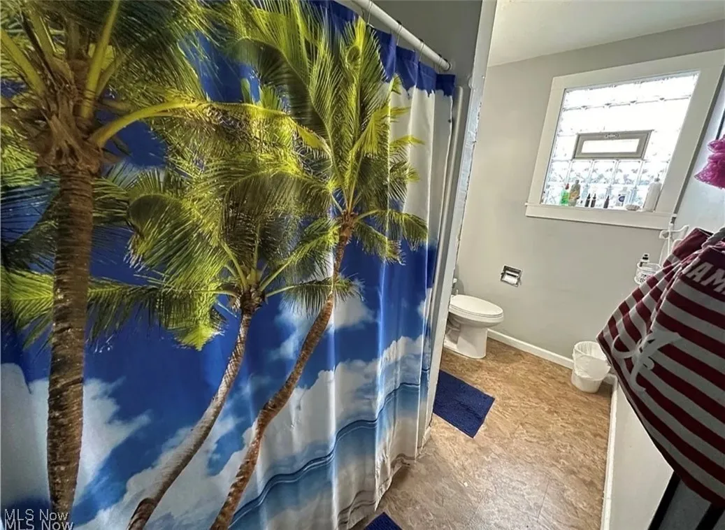 Bathroom with toilet and baseboards
