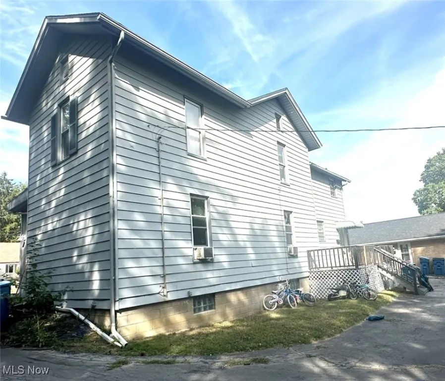 View of home's exterior featuring a wooden deck