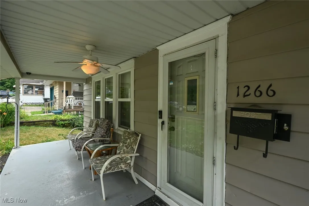 Covered porch featuring a ceiling fan