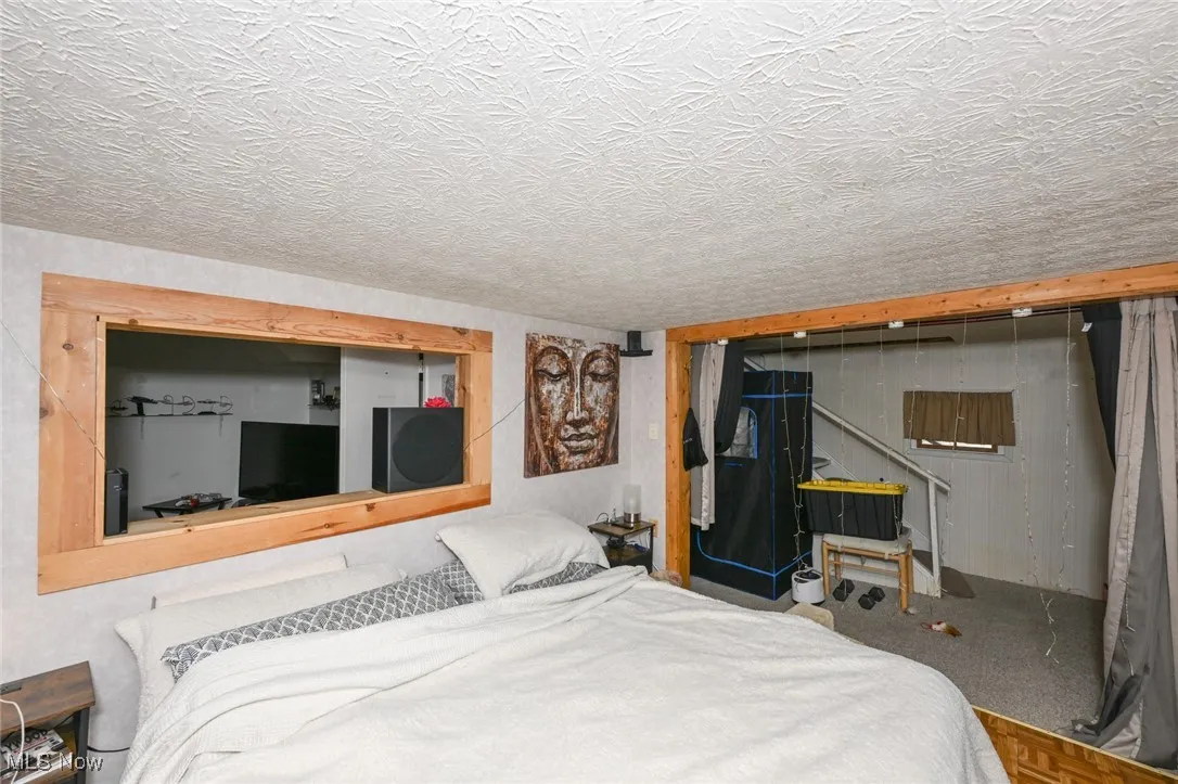 Bedroom with a textured ceiling