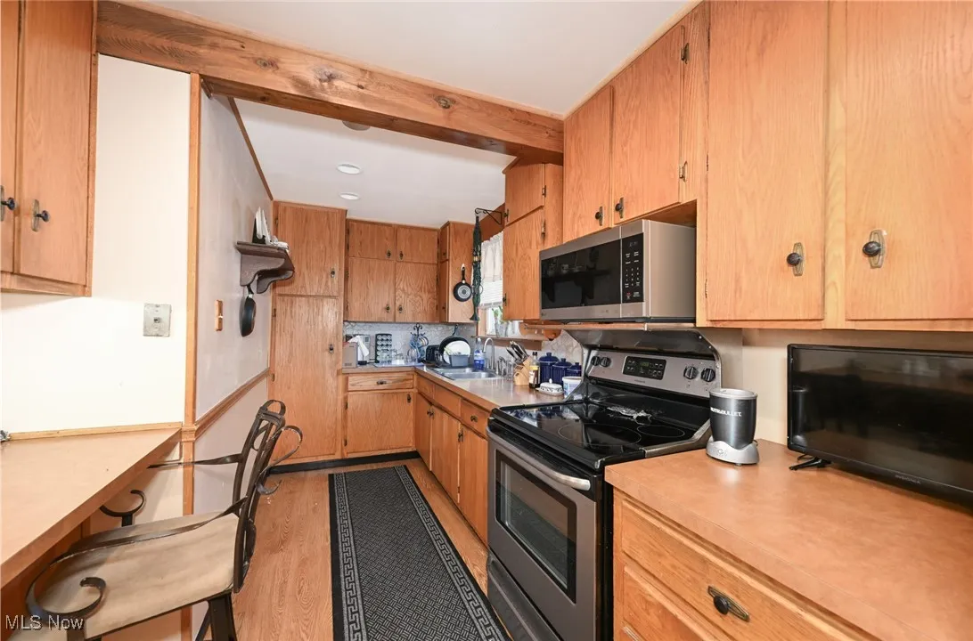 Kitchen featuring stainless steel appliances, light wood finished floors, light countertops, decorative backsplash, and recessed lighting