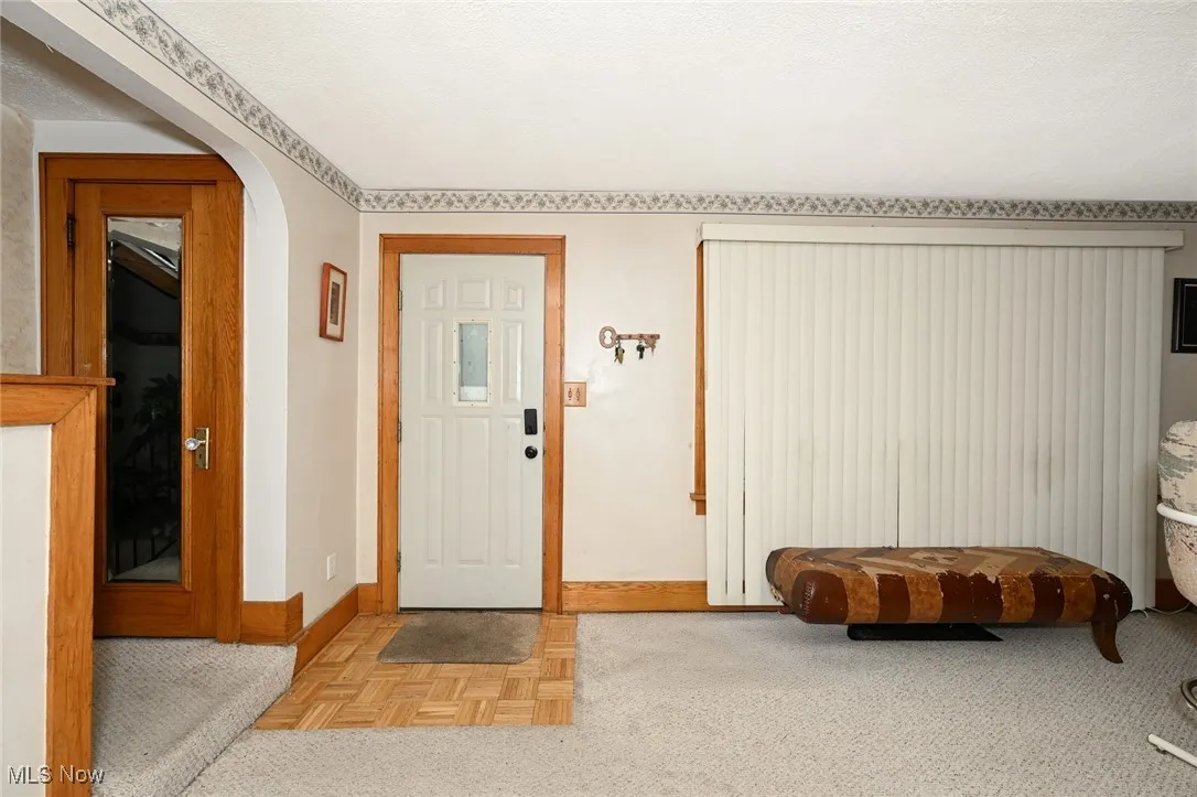 Foyer entrance featuring baseboards and arched walkways