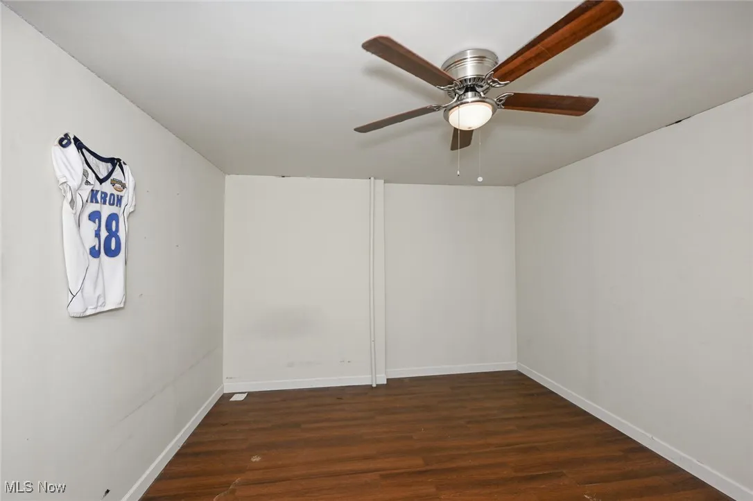Unfurnished room with wood finished floors and ceiling fan