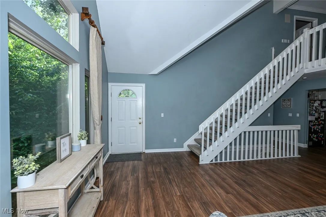 Entrance foyer with stairway and wood finished floors