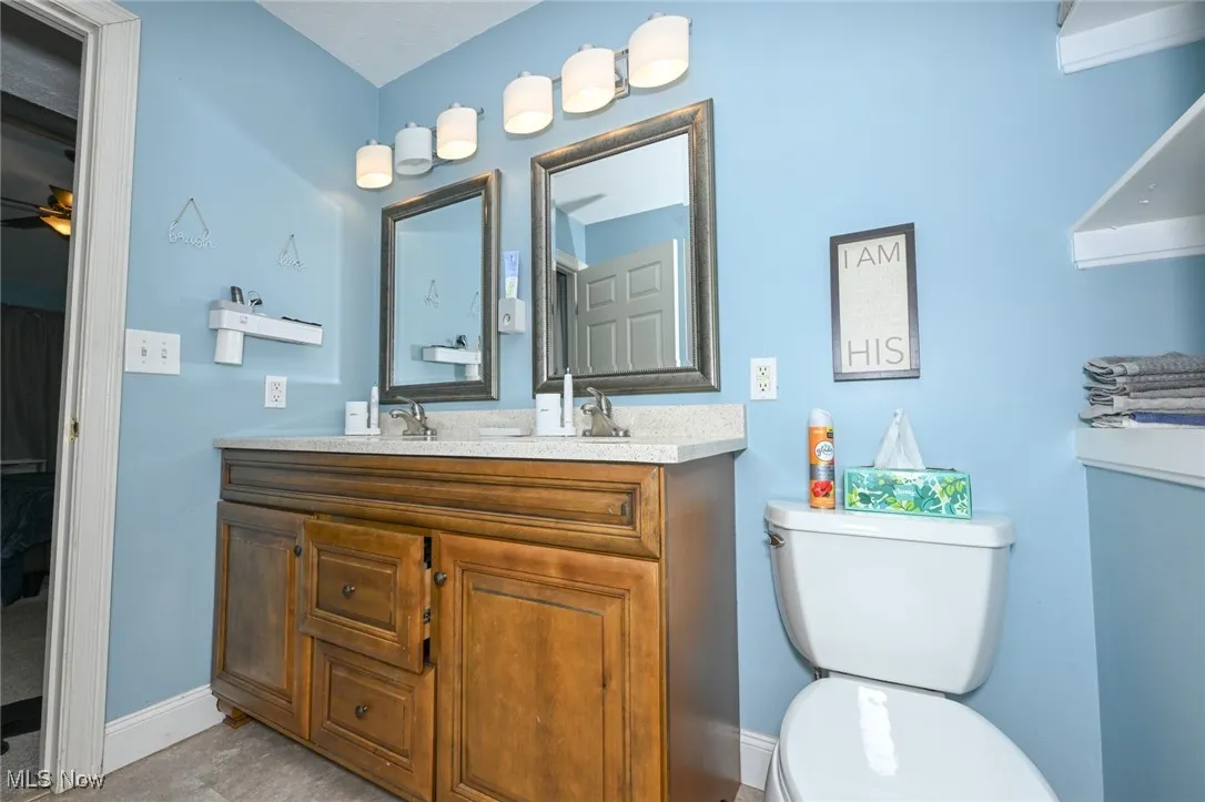 Bathroom with toilet and double vanity