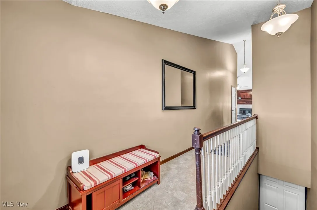 Hallway with an upstairs landing and baseboards