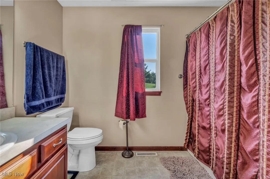 Full bathroom featuring vanity and a shower with curtain