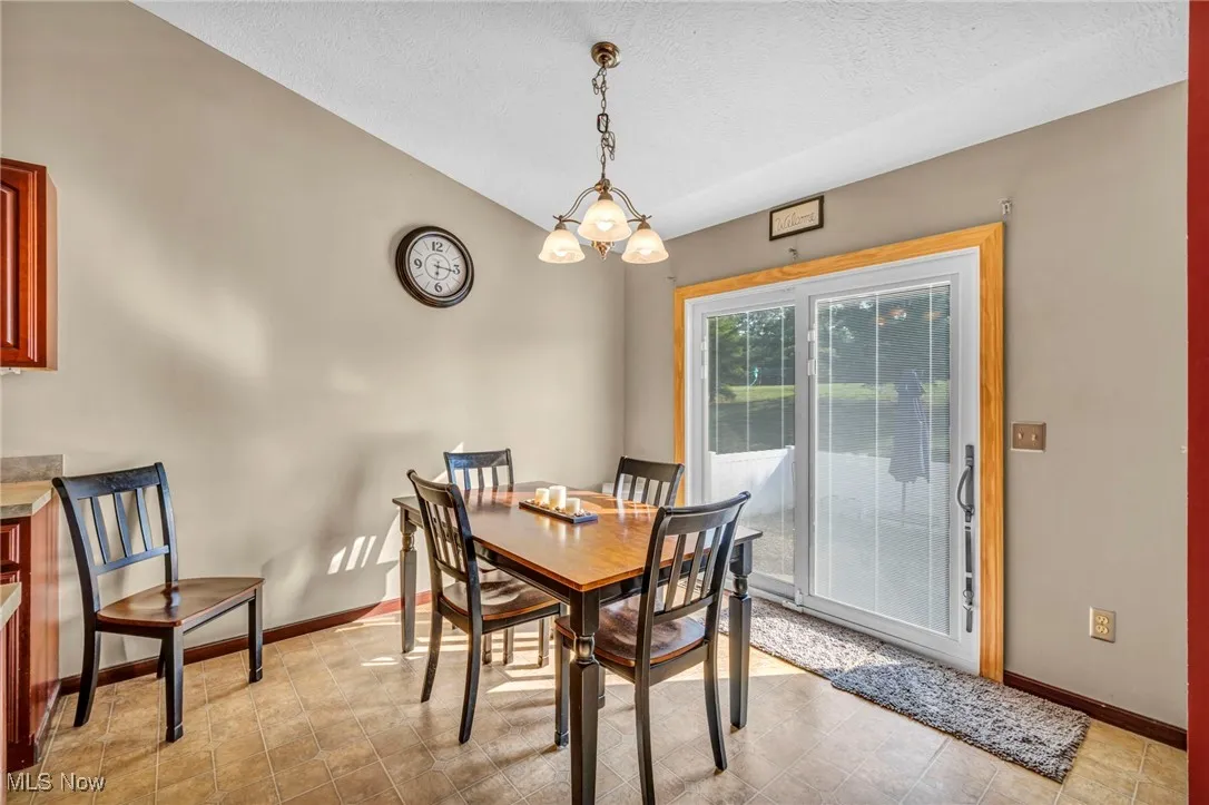 Dining space featuring a textured ceiling and baseboards