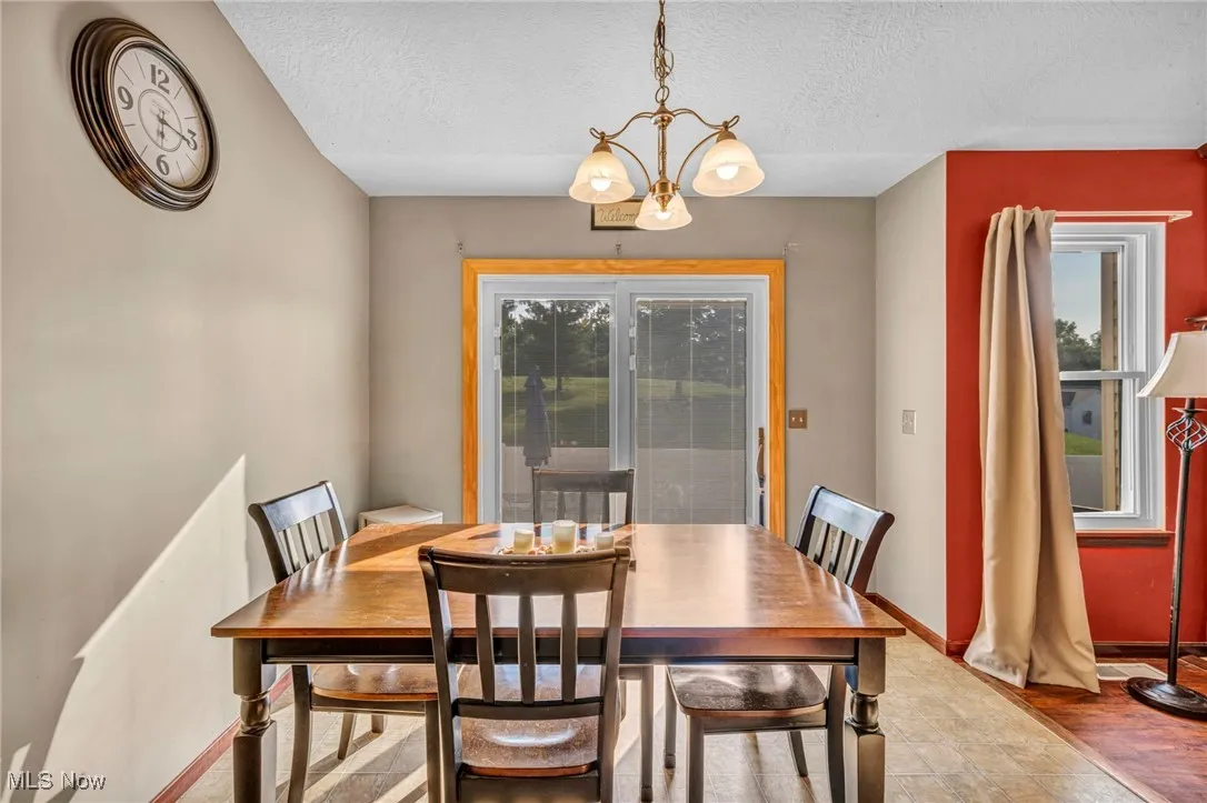 Dining room featuring a chandelier and a textured ceiling