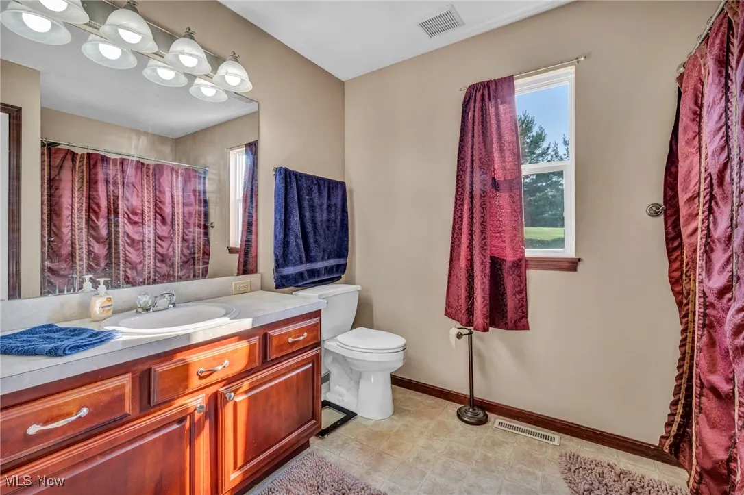 Full bathroom featuring vanity and a shower with shower curtain