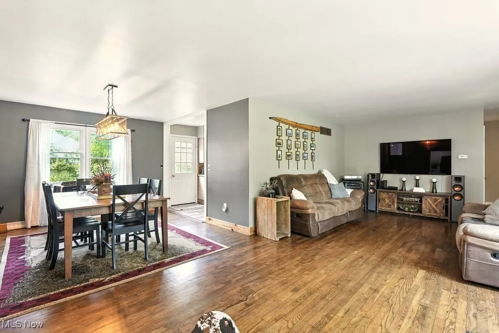 Living Room with Brick Wood-Burning Fireplace with Hearth and View of Dining Room