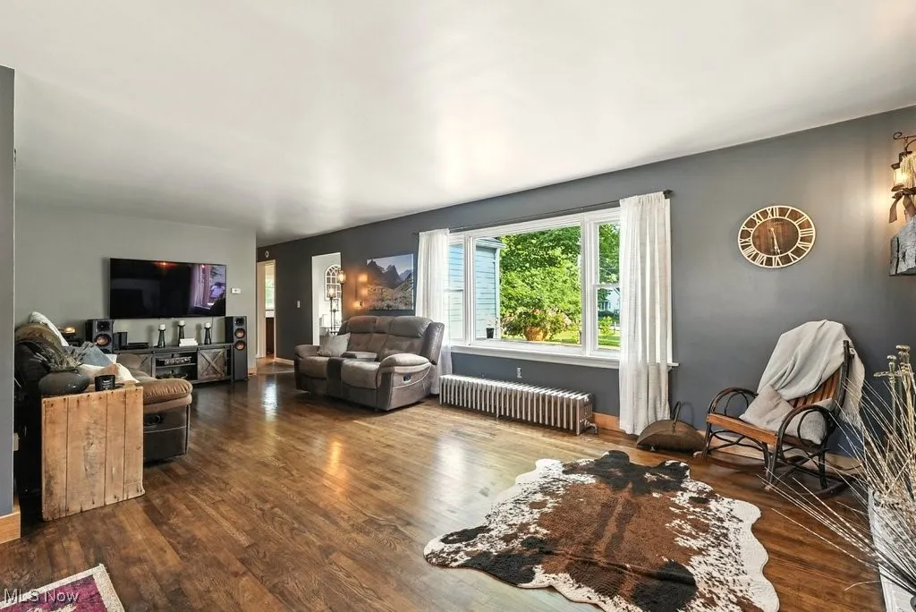 Living Room with Brick Wood-Burning Fireplace with Hearth