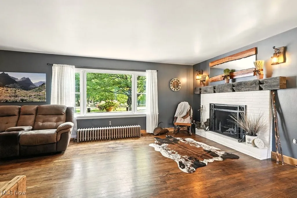 Living Room with Brick Wood-Burning Fireplace with Hearth