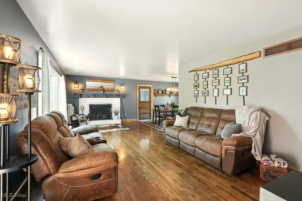 Living Room with Brick Wood-Burning Fireplace with Hearth