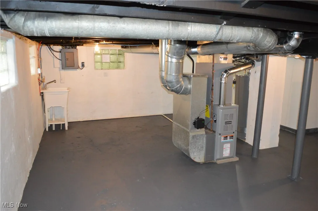 Basement with electric panel and heating unit