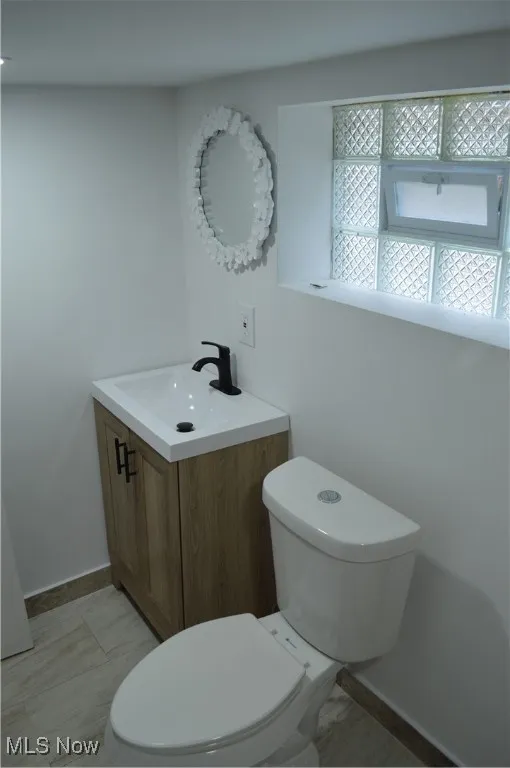 Half bath with vanity and toilet