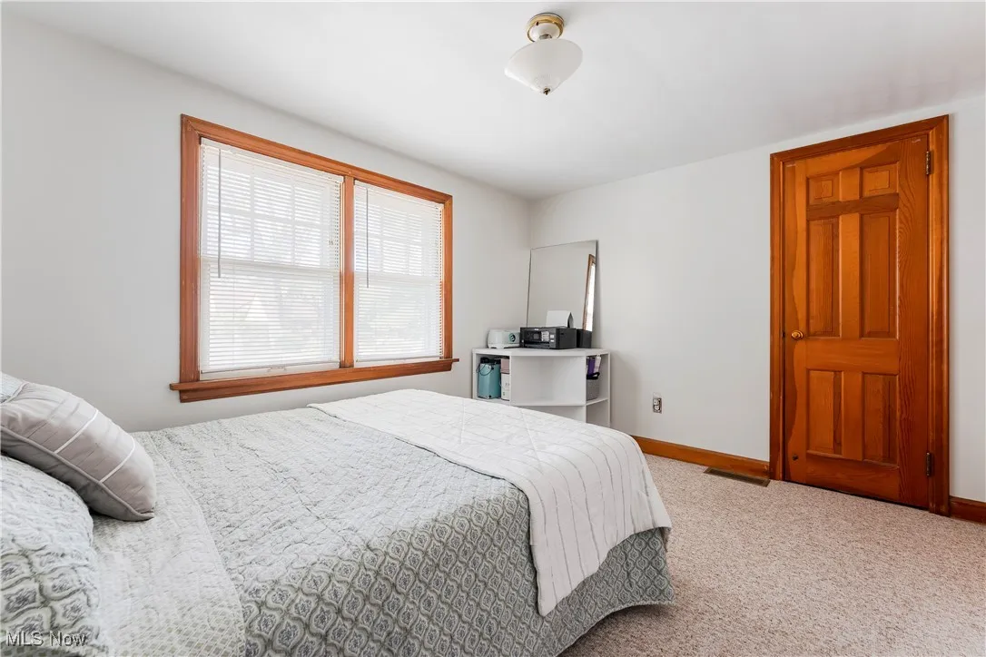Bedroom with carpet flooring and baseboards