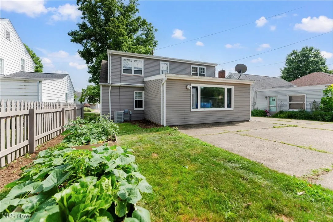 Back of property featuring a vegetable garden